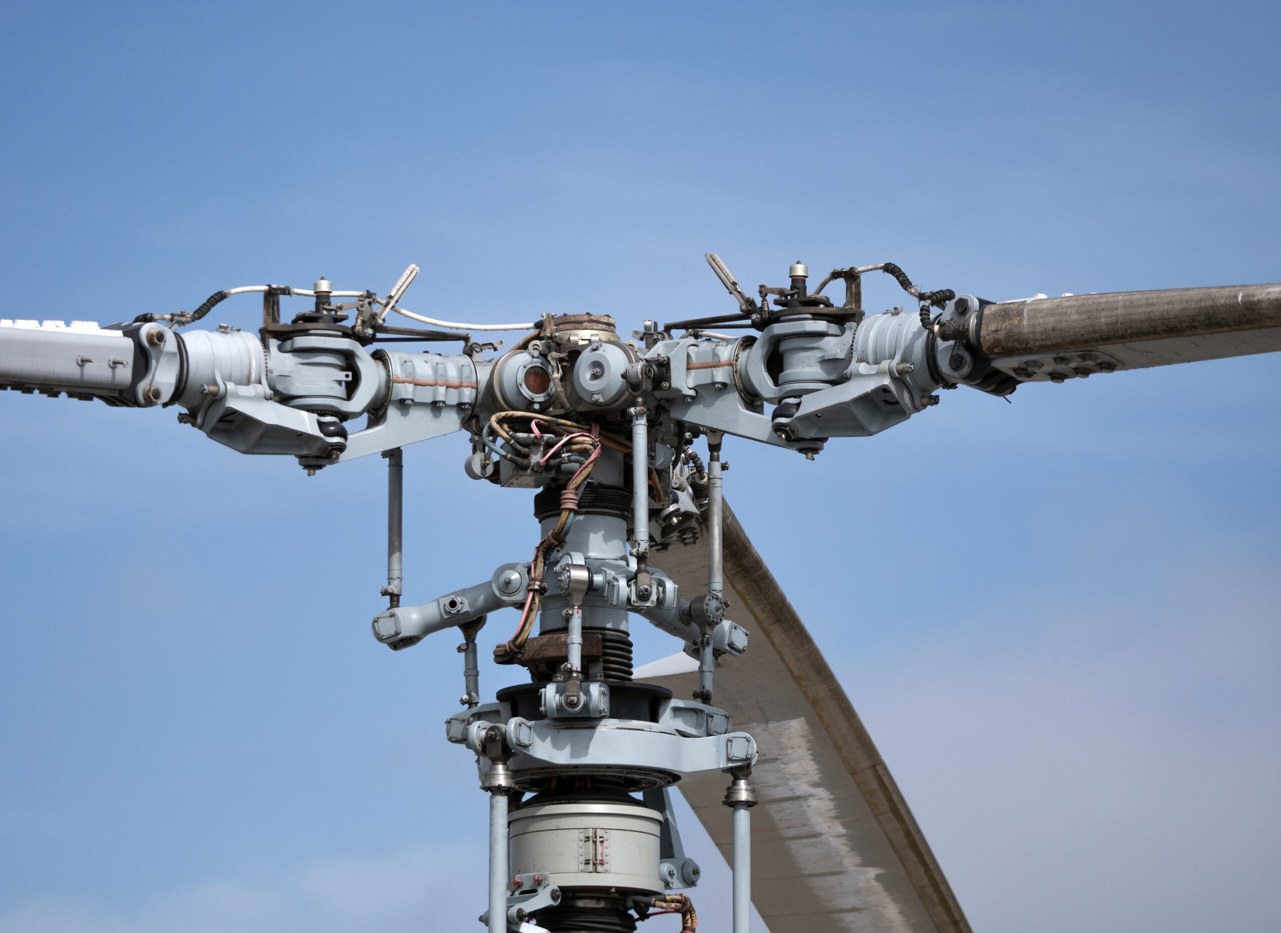 The mechanism of screws military helicopter on the background of blue sky, a close-up